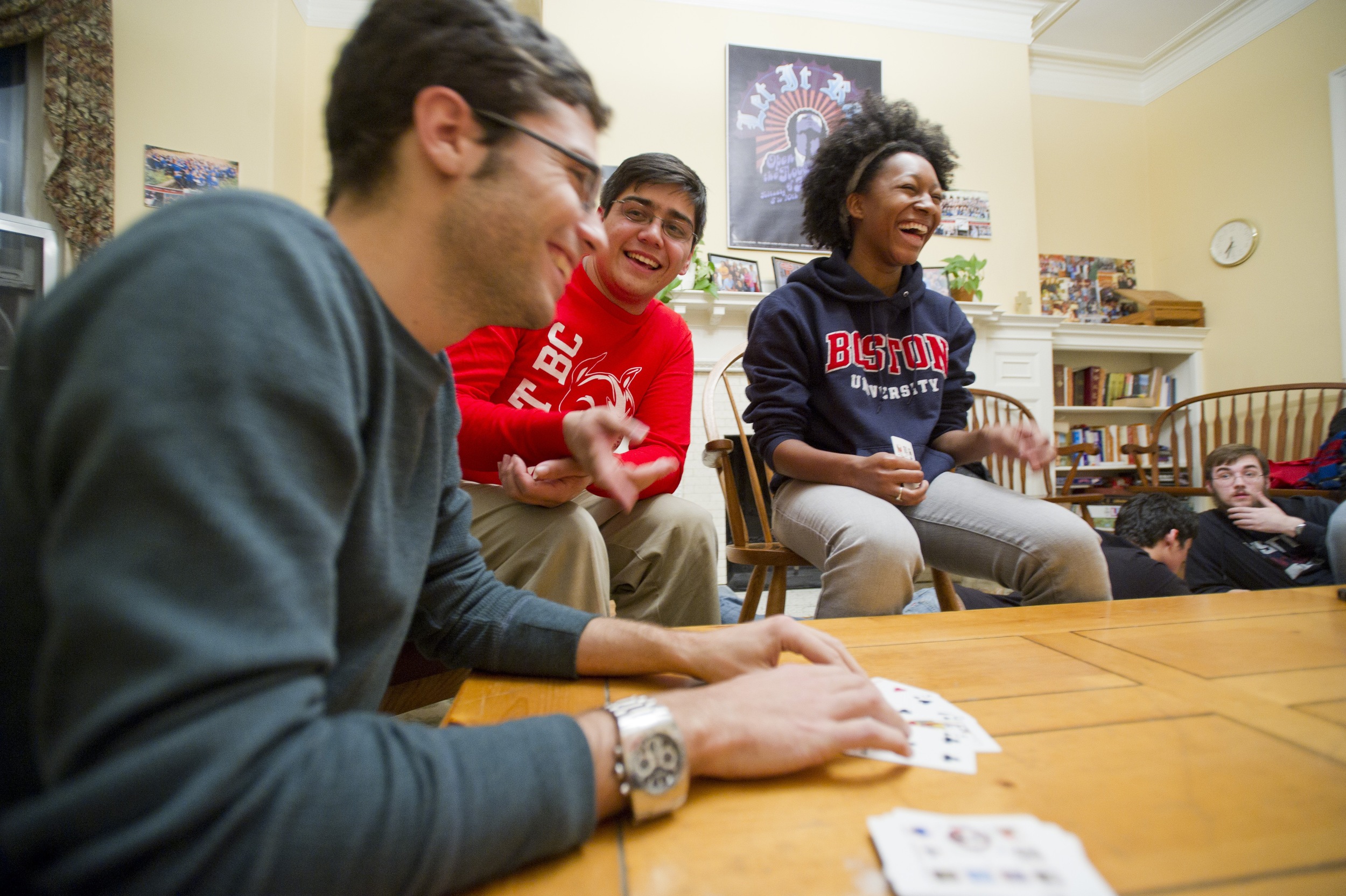  Joan Diaz-Laviada, left, who is a one-semester exchange student in LAW from Madrid, explains the tricky card game "Moose" while Howard Male (SHA, SMG,'12) and Dorothy Adams (SAR,'13) take mental notes November 22, 2011 during Game Night at The Catho