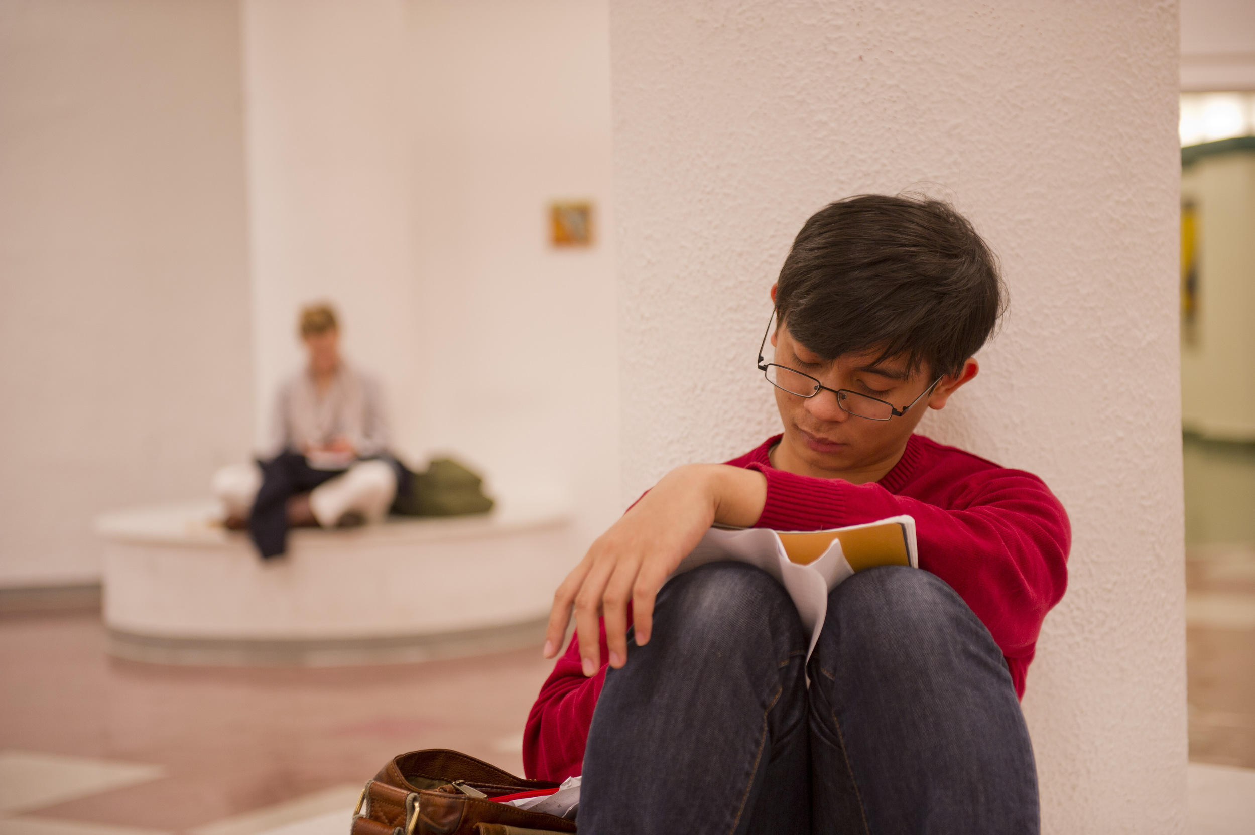  Mario Feranio (SAR,'13) waits in the lobby at CFA for his music theory class November 30, 2011. &nbsp;Photo by Cydney Scott for Boston University Photography 