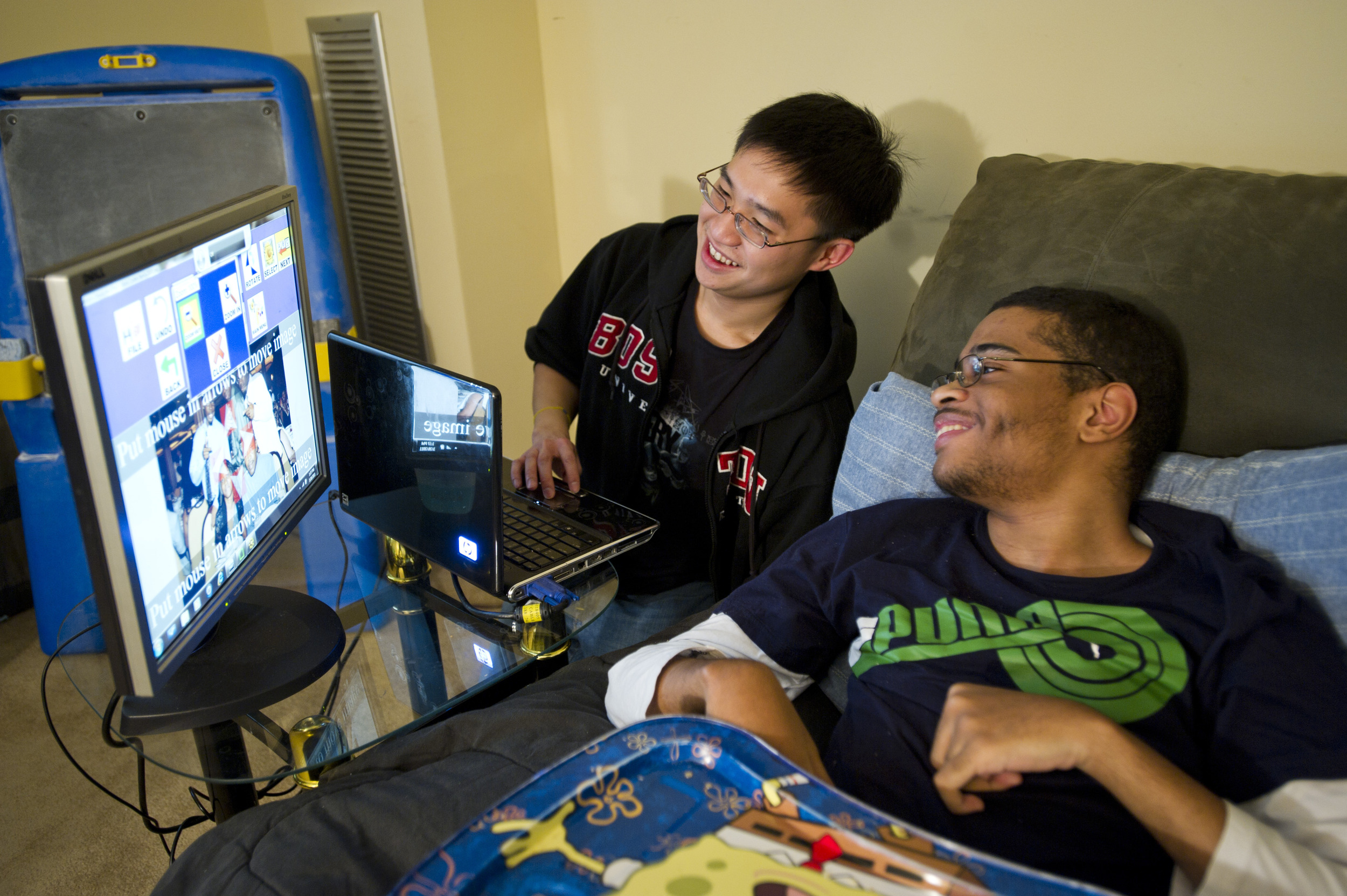  Chris Kwan, at left, is a computer science research student in UROP who is developing a software that allows users will mobility impairments to edit photos. Here, Kwan shows his software to Corey Petitt of Boston and has him try out they editing sys