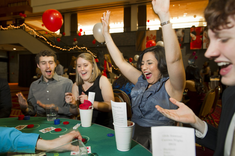  Aaron Fisher-Katz (ENG,'14), left, &nbsp;Sarah Wiegard (SAR,'13), second from left, and Kevin Flynn (CAS,'14), right, look on while Ana Sofia Camacho (ENG,'13), celebrates the hand she was dealt during the 15th Annual Casino Night at the GSU Februar