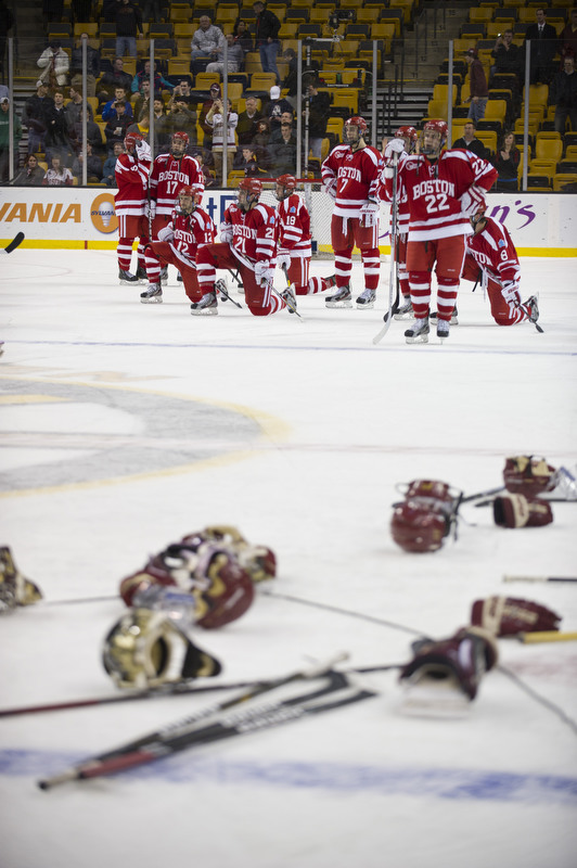  BC Eagles gear litters the ice as BU Terriers look on as the BC Eagles celebrate their overtime victory after the Men's Beanpot Final between BU and BC at the TD Garden on Monday, February 13, 2012.  Photo by Cydney Scott for Boston University Photo