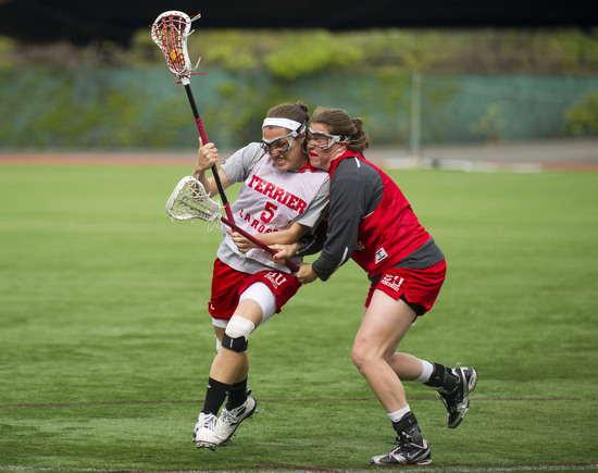  Elizabeth Morse (CGS'14), left, tries to keep possession of the ball with teammate Siobhan McCarthy (CGS'15) on defense during drills at BU women's lacrosse varsity team practice April 24, 2012 at Nickerson Field.&nbsp;    