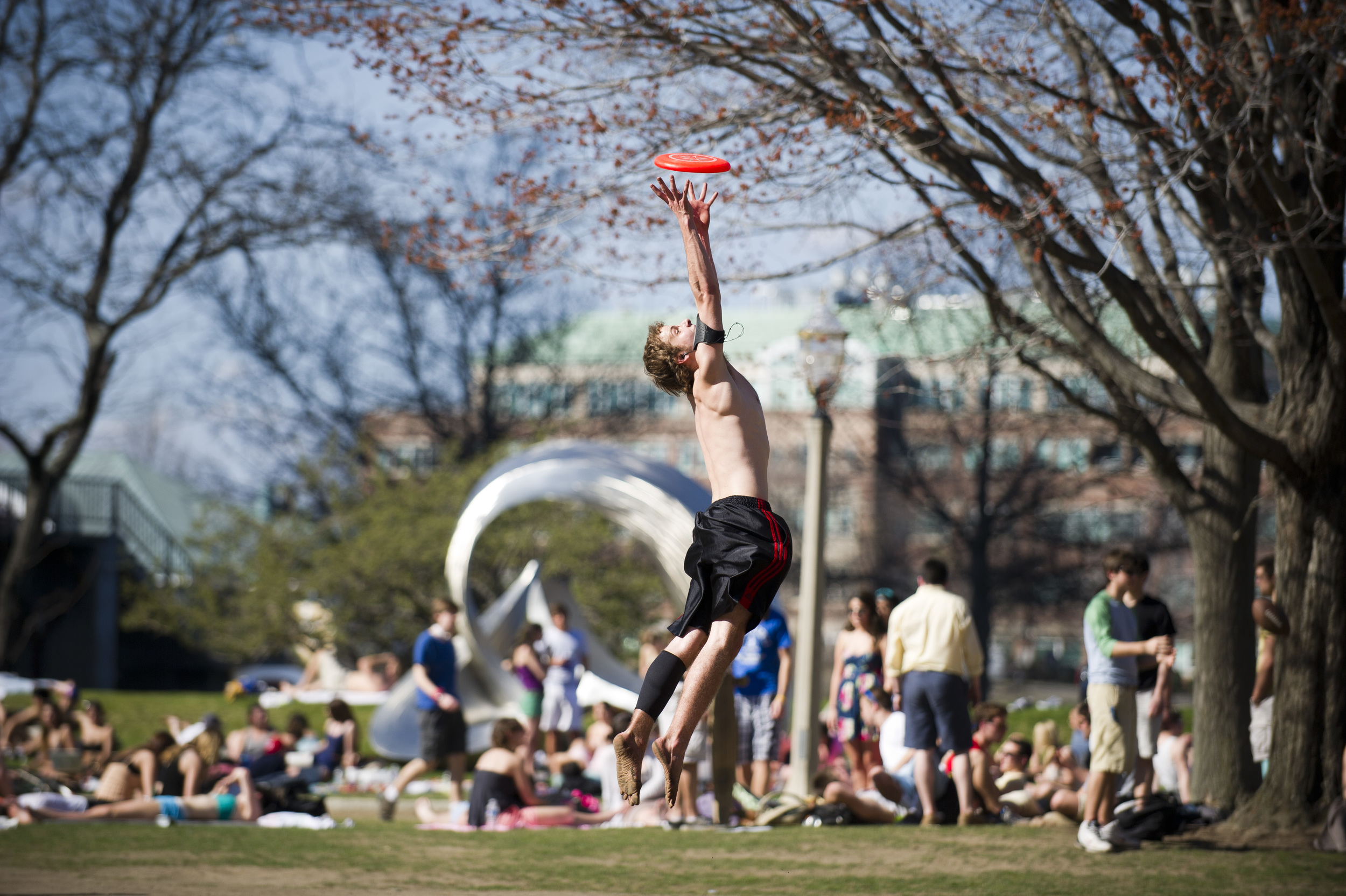  Andy Beckenbach (ENG'13) enjoys some frisbee with friends on BU Beach March 22, 2012. The crowd at BU Beach was massive thanks to the bright sun and hot temperatures.  Photo by Cydney Scott for Boston University Photography 