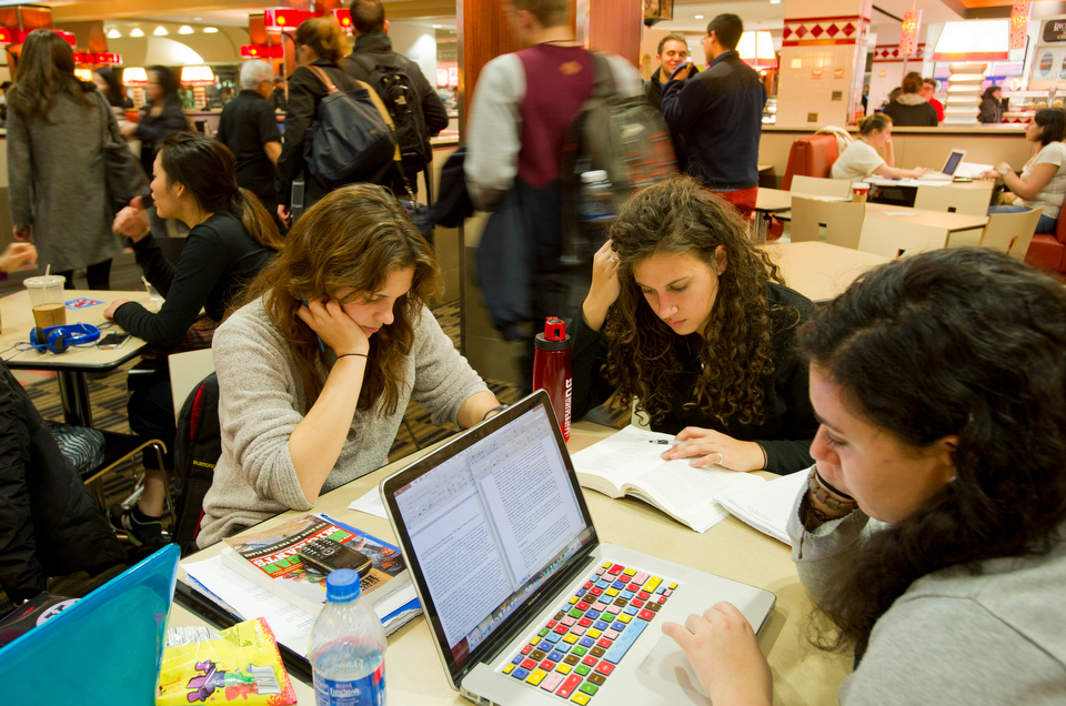  Jessica Hylek (CAS'15) from left, Julia Catalini (SED'14) and Vanessa Zarba (COM'15) grab a bite and hit the books int he GSU dining hall December 11, 2012 in preparation for finals.&nbsp;   Photo by Cydney Scott for Boston University 