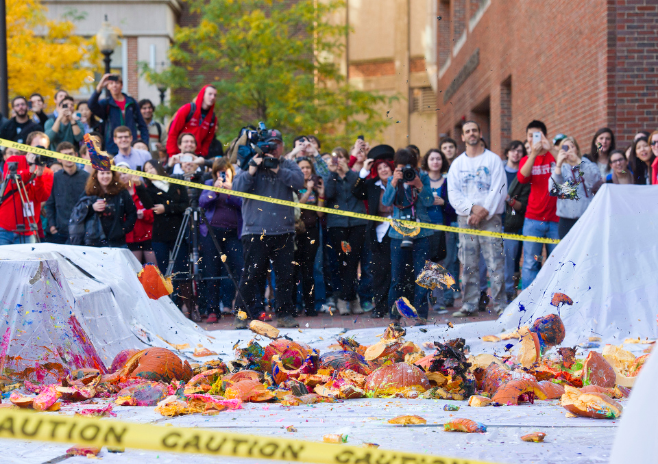  A 78 pound pumpkin, the largest of all tossed from the roof of the Metcalf, lands at the foot of the Metcalf Science Center during the Annual Pumpkin Drop October 26, 2012.&nbsp;  Photo by Cydney Scott for Boston University 