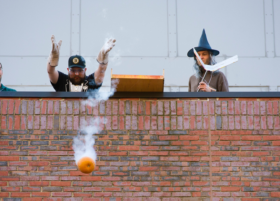  Professor Martin Schmaltz, at right, looks on while John Ogren (ENG grad) lets go of a pumpkin that's been frozen in liquid nitrogen off the roof of the Metcalf Science Center during the Annual Pumpkin Drop October 26, 2012.&nbsp;  Photo by Cydney S