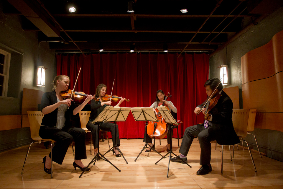  Heather Braun (CFA '08,'13), from left, and Rose Drucker (CFA'04), Agnes Kim (CFA'10, and BU string department faculty member Daniel Dona (CFA '05, '09) &nbsp;of The Arneis Quartet performs in Newton Upper Falls October 13, 2012 during the Carriage 