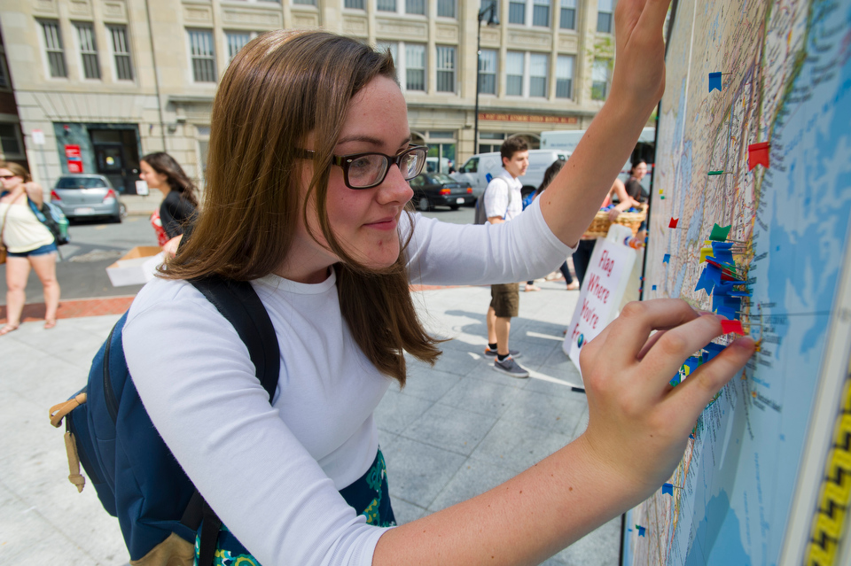  Michelle LeCorn (CAS'14) of Taunton, MA marks her hometown with a pin on a giant map located outside 100 Bay State Road during BU's Comm Ave Fair September 7, 2012. The world map was provided by the Student Program and Leadership Office.&nbsp;   Pho