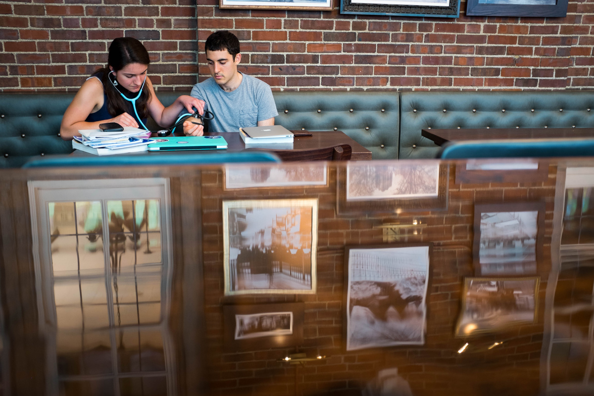  These two were studying together in the student union where a table carved into in 1909 stayed shiny with an epoxy coating.&nbsp; 