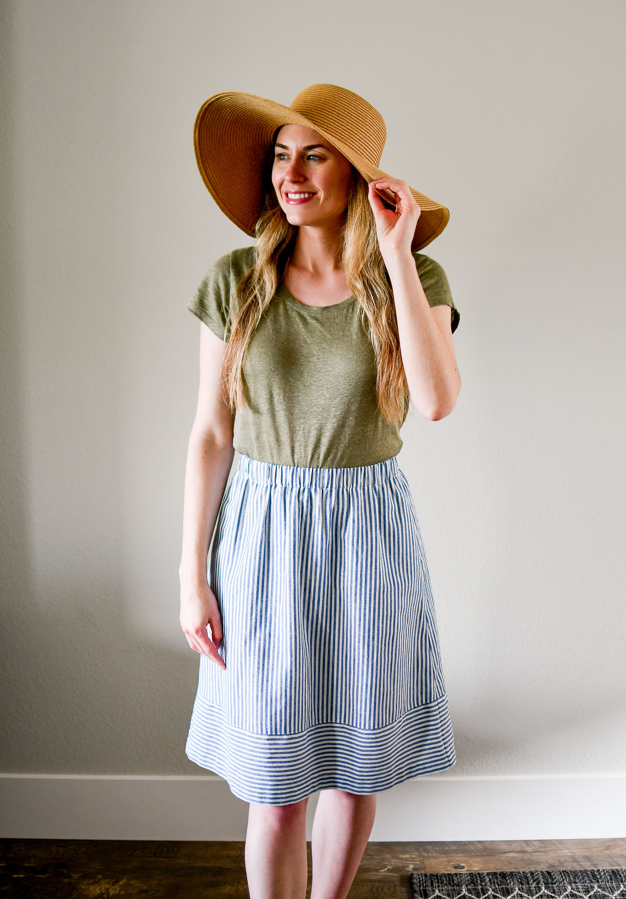 Straw sun hat, green linen tee, striped midi skirt — Cotton Cashmere Cat Hair