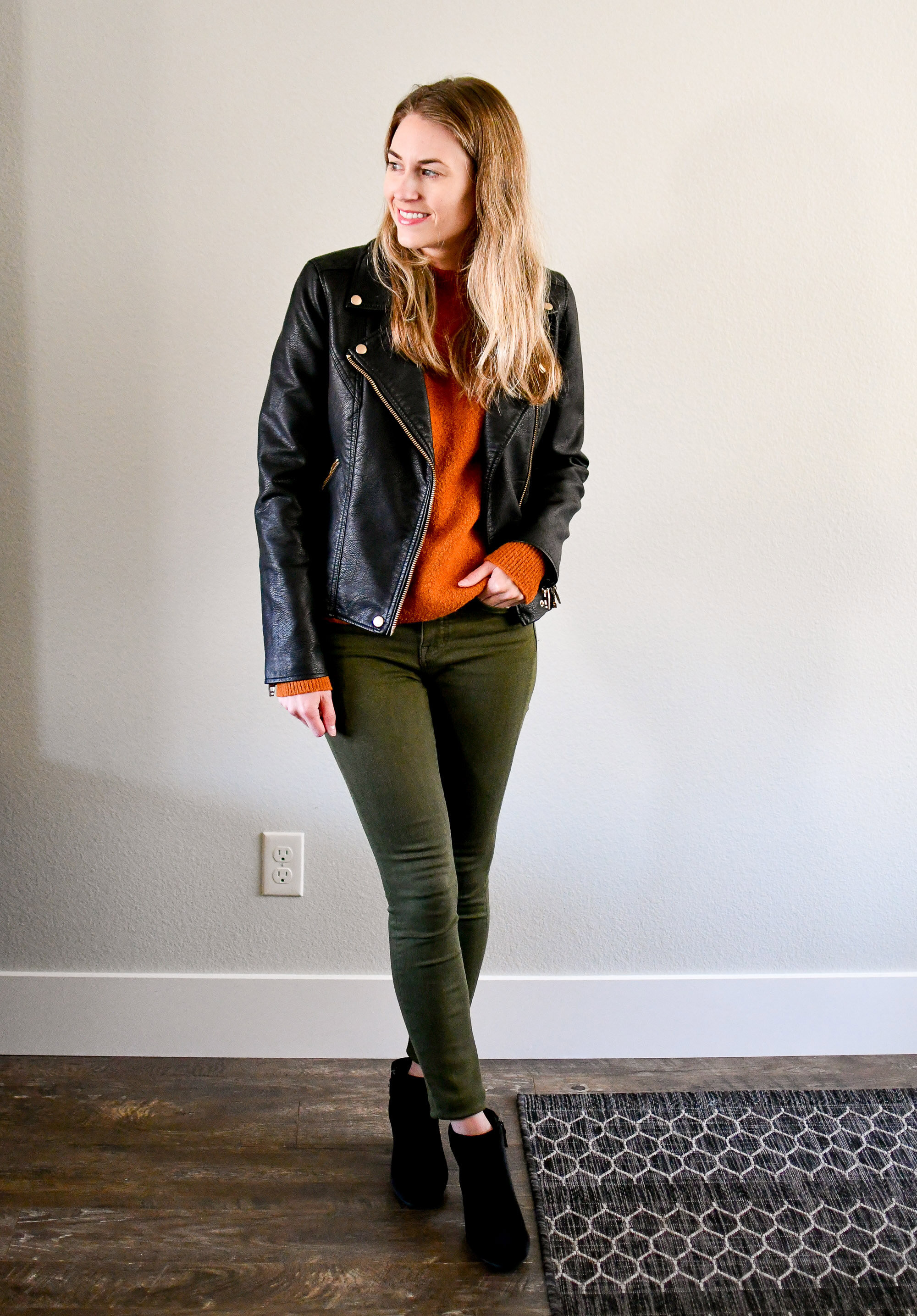 Leather jacket, orange-brown sweater, olive jeans, black boots — Cotton Cashmere Cat Hair