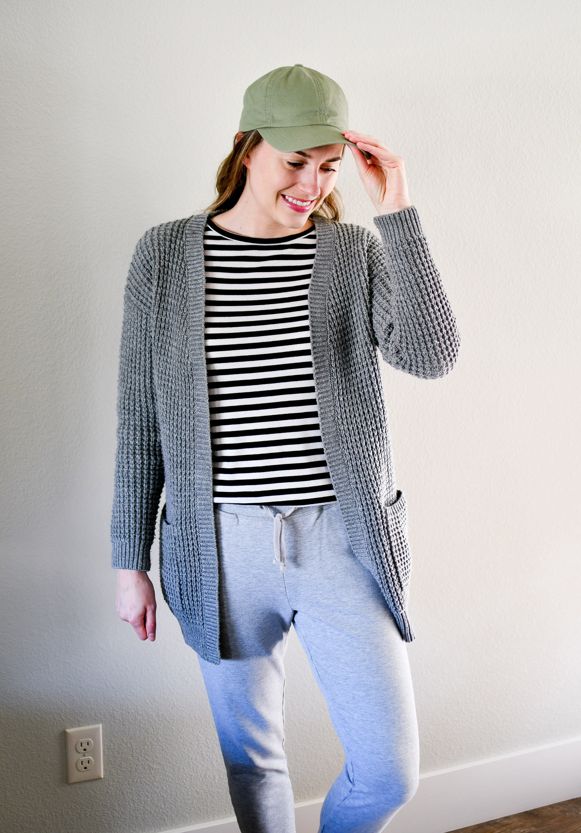 Chunky knit cardigan spring outfit with striped tee and baseball cap — Cotton Cashmere Cat Hair