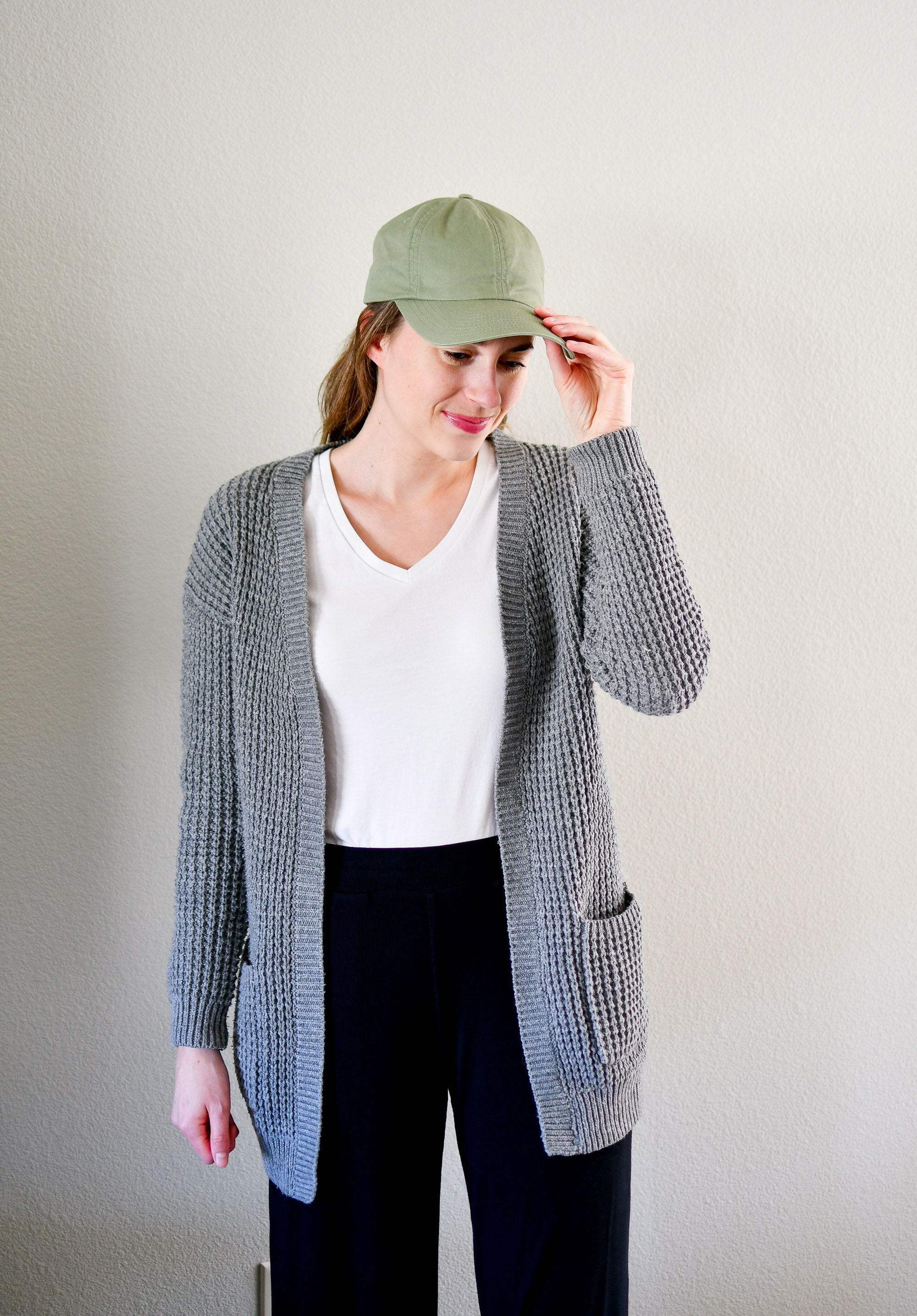 Casual spring outfit with olive green hat, grey cardigan, white tee — Cotton Cashmere Cat Hair