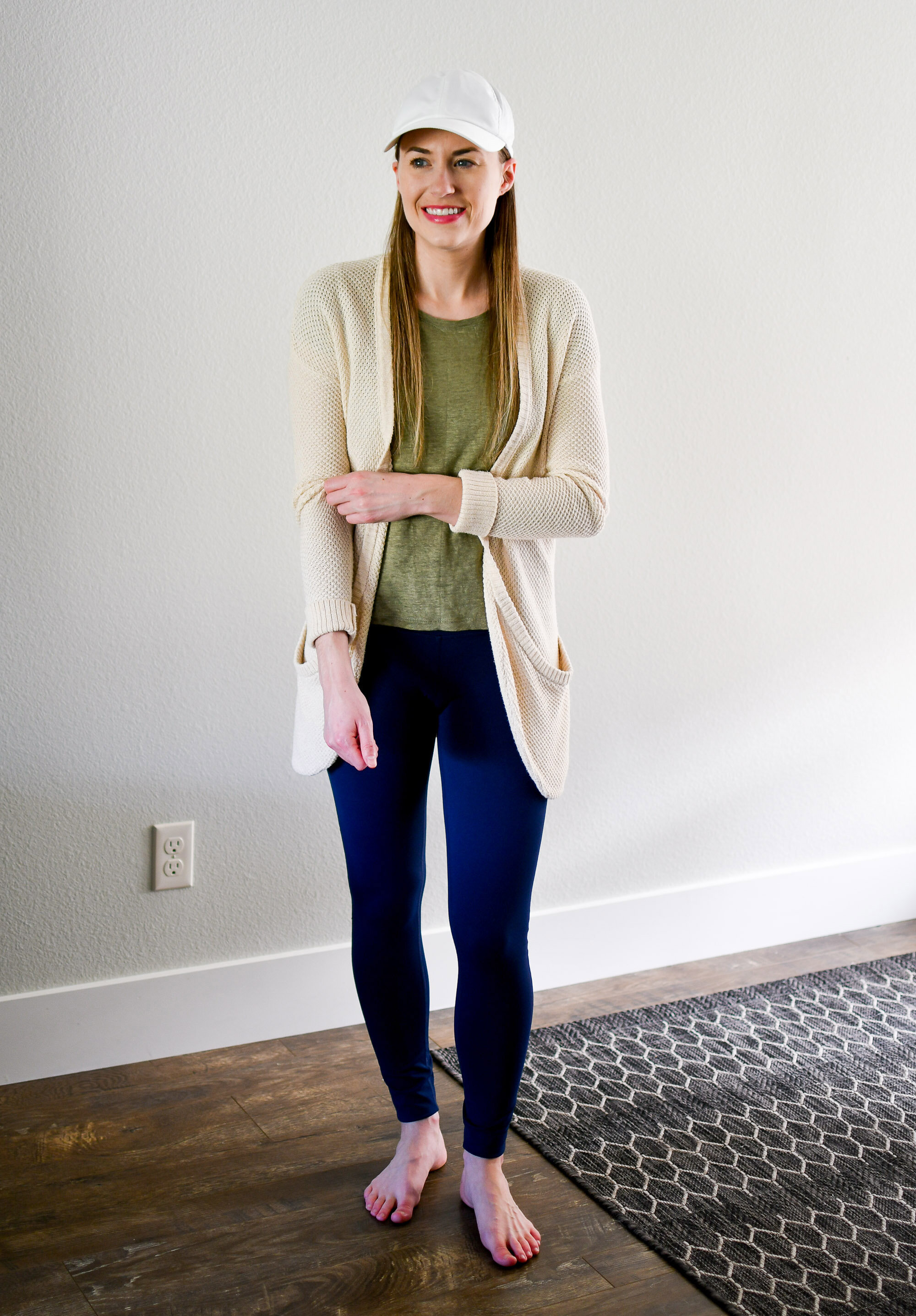Work from home spring outfit with cream cardigan, green linen tee, navy leggings — Cotton Cashmere Cat Hair
