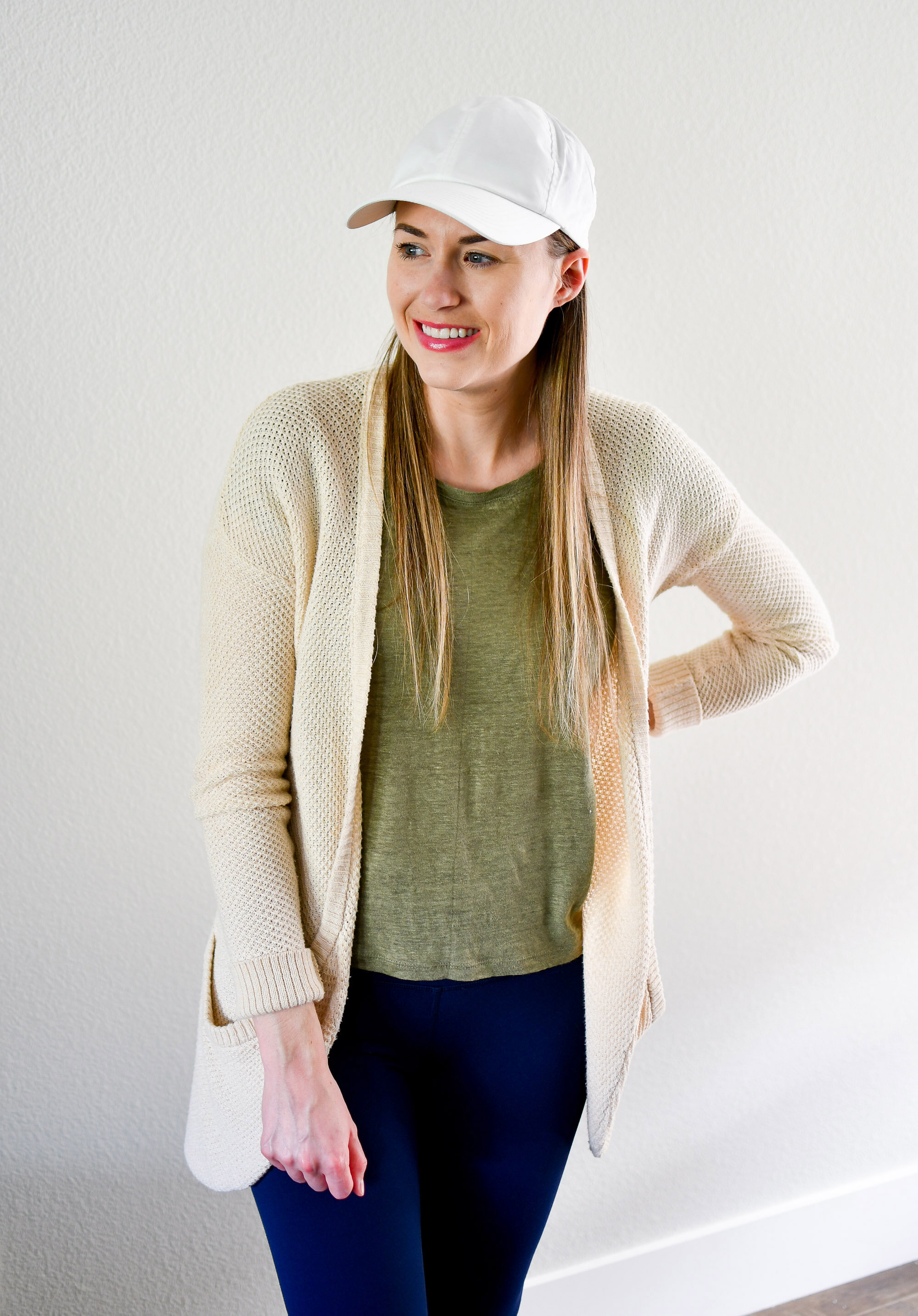 Casual spring outfit with white baseball cap, cream cardigan, green linen tee — Cotton Cashmere Cat Hair