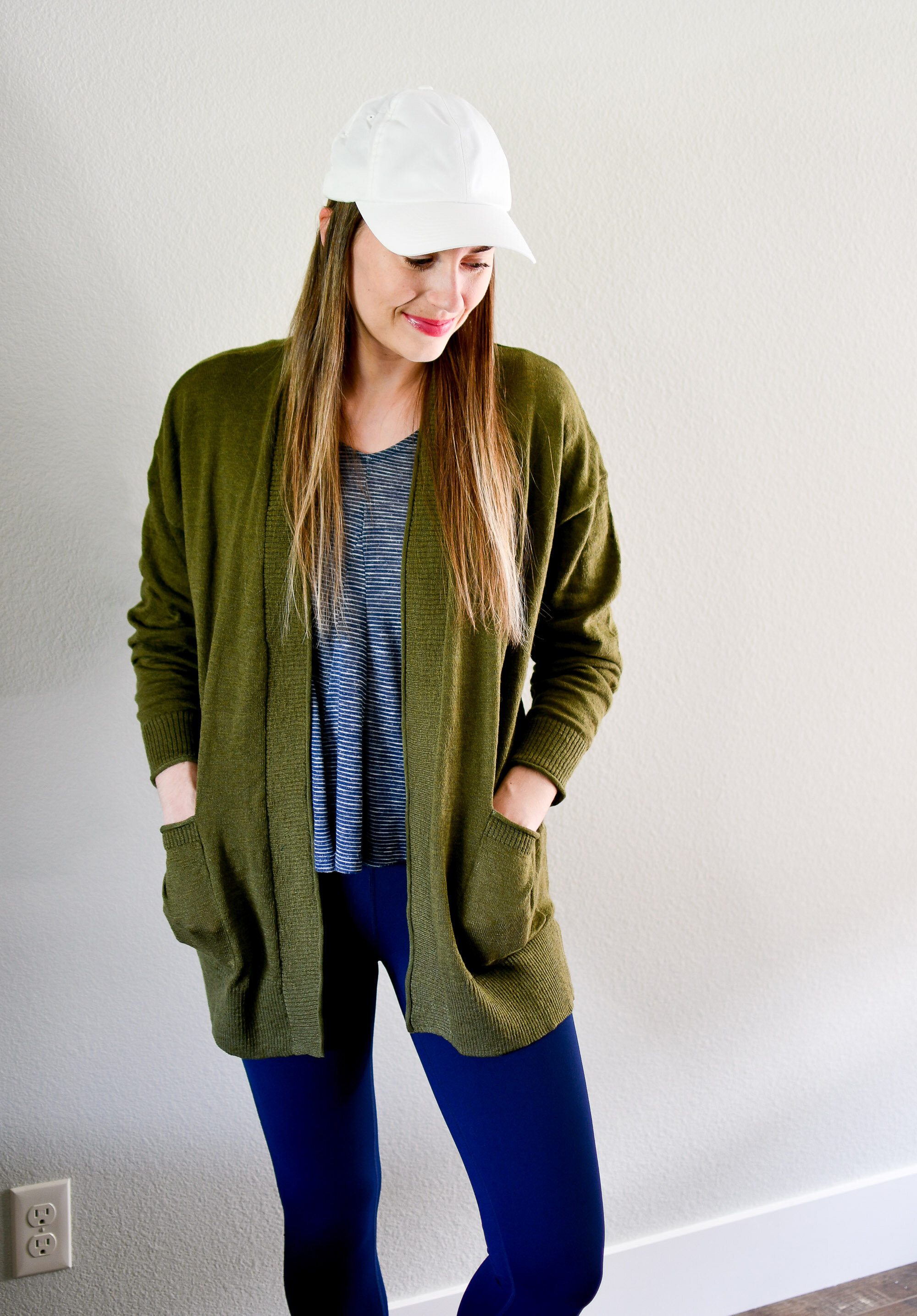 Casual spring outfit with white baseball cap, green cardigan, navy striped top — Cotton Cashmere Cat Hair