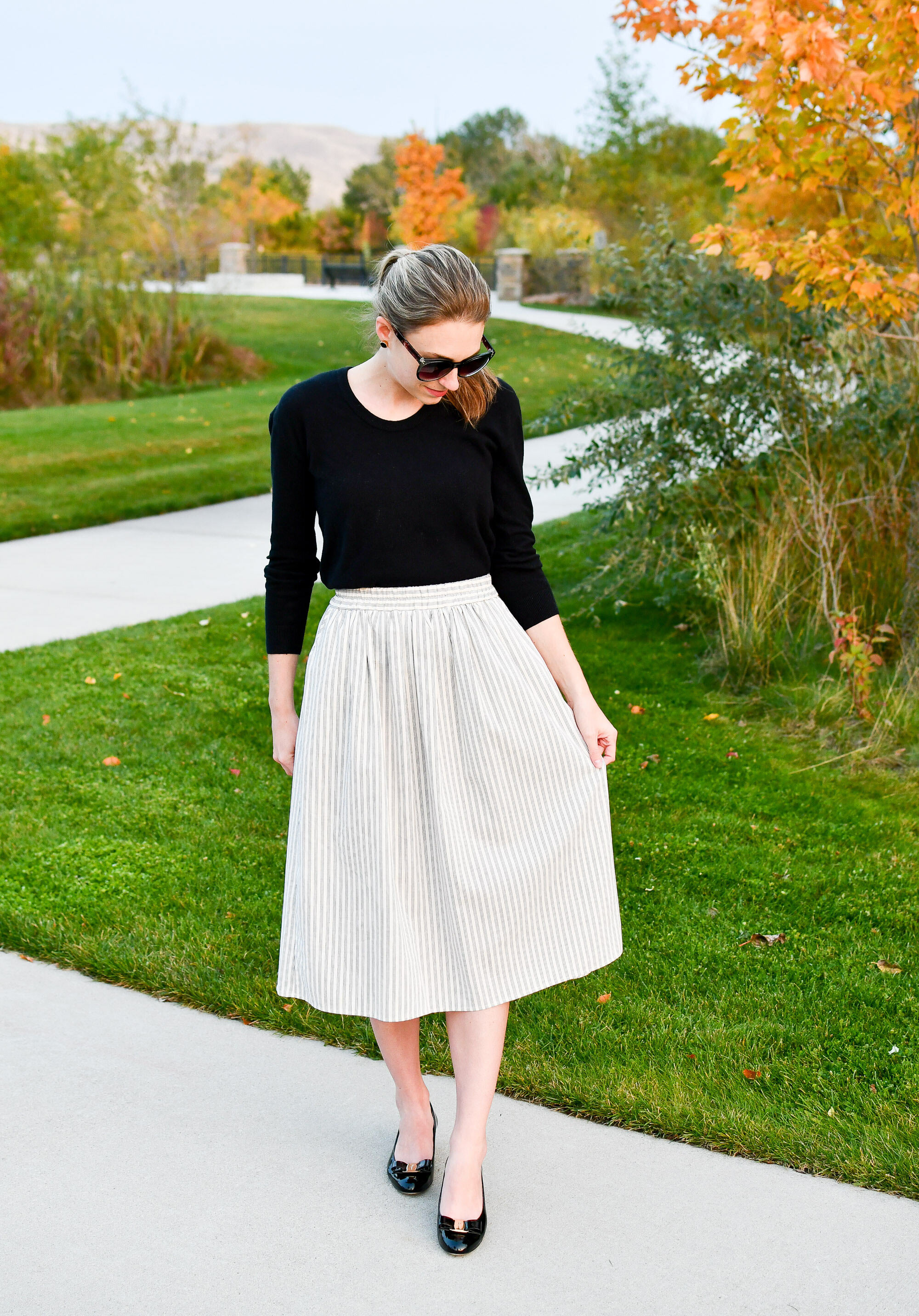 Fall outfit to wear to work from home / black sweater + striped midi skirt + Ferragamo pumps — Cotton Cashmere Cat Hair