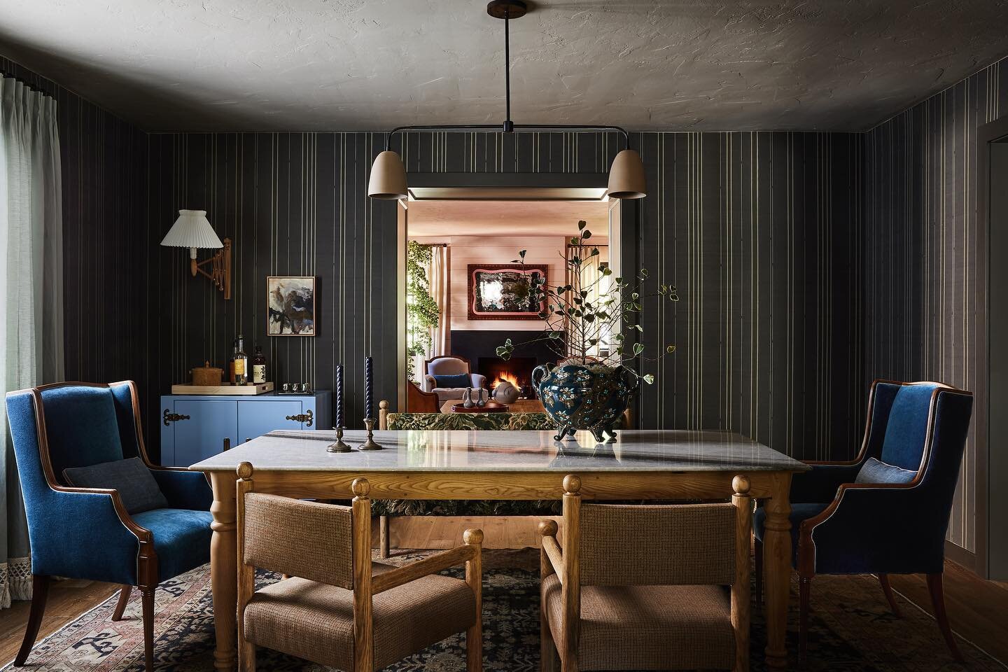 One of my favorite dining room transformations. Perfectly imperfect striped grasscloth wallpaper is complemented by our signature style accents and moody material mix. It's all about striking a balance and selecting elements that combine to create an