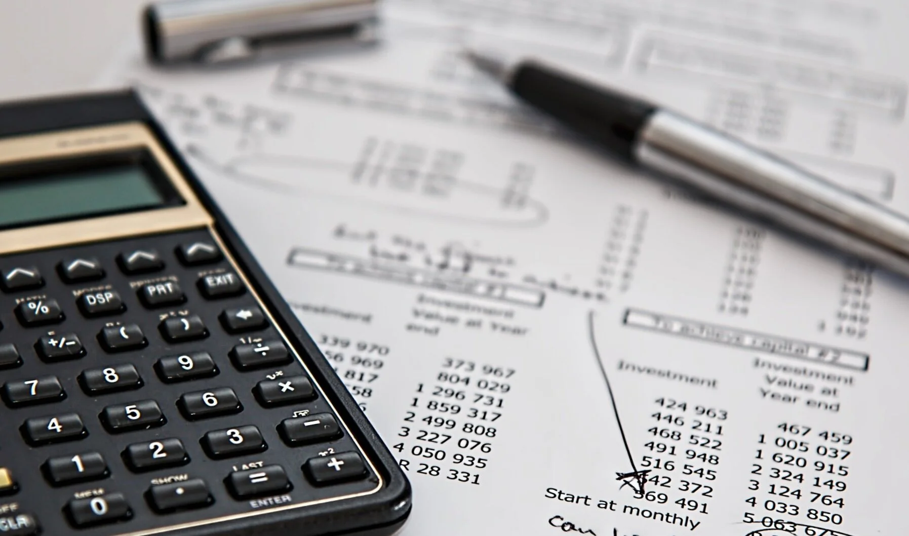 black-calculator-near-ballpoint-pen-on-white-printed-paper-53621.jpg