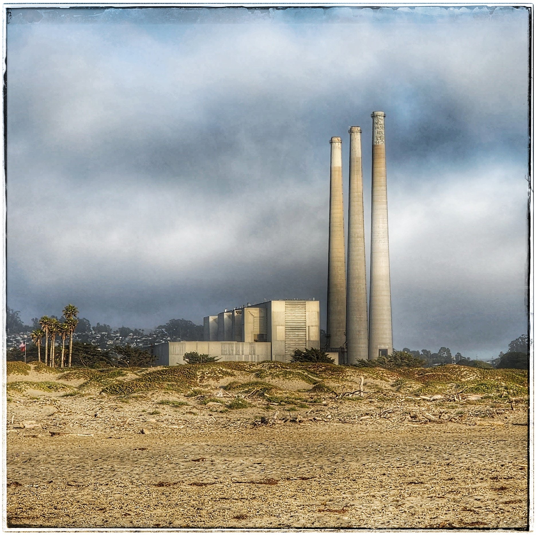  A view of the old PG&amp;E power plant with smokestacks looking east from Morro Strand State Beach at Morro Bay, California. 