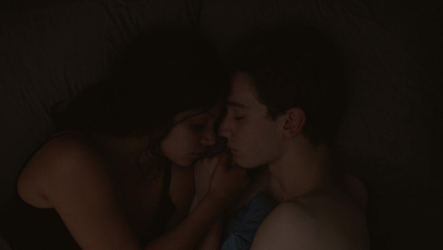 Guillaume and Charlotte lie in bed.
