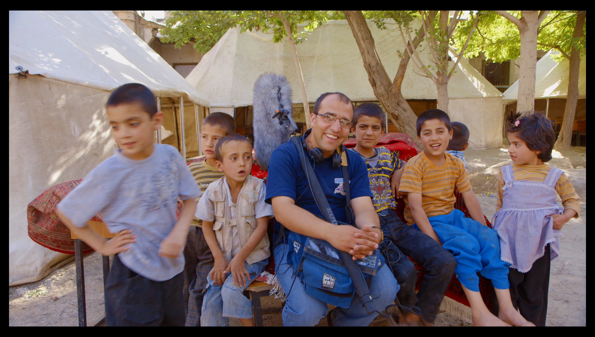 Sound recordist Jamshid Amiry with neighborhood kids at the Daqiqi Balkhi school, Kabul, Afghanistan