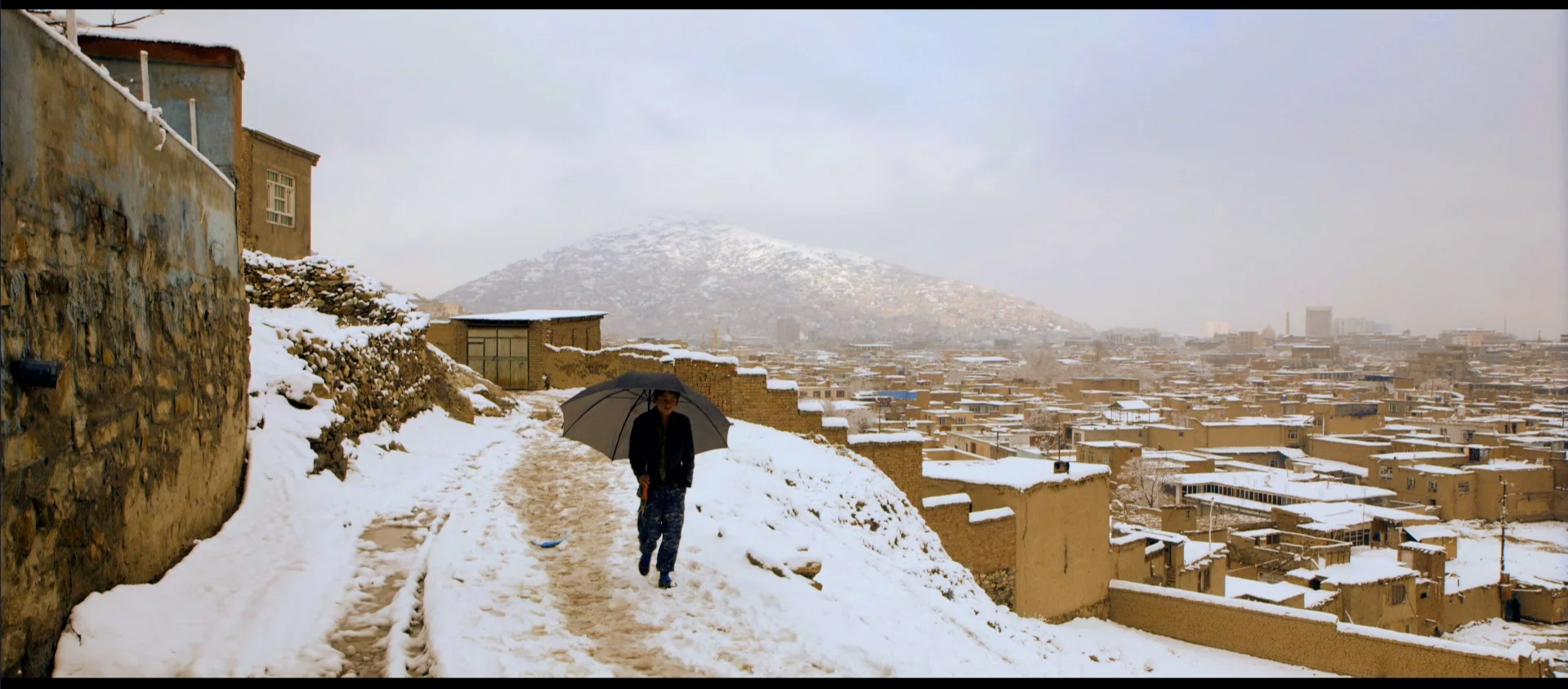 Film still: A snowy day in the neighborhoods above Kabul