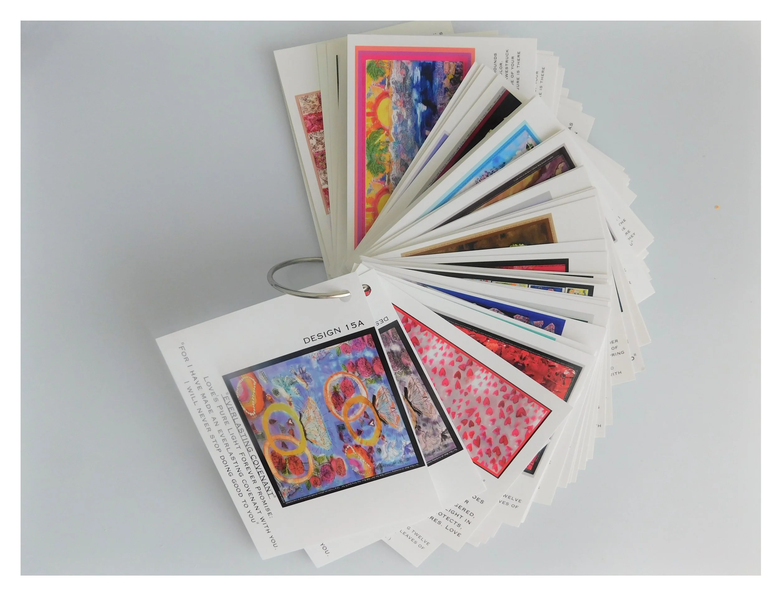 Picture of our flip books offered to every retailer to help showcase the beauty and descriptions of promises inscribed on each luxury shawl we hand paint!