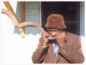 Solomon Guwazah, a railway clerk and musician who lives in the small Zimbabwean city of Rusape, converted from Rastafarianism to Judaism several years ago when he decided that his people, the Shona people of Southern Africa, very likely descended from the ancient Jews. He, and many other community members who have come to the same conclusion, based this belief on the fact that many Shona cultural practices are more similar to those found in the Old Testament than to those practiced by Zimbabwean Christians. He is shown here blowing a shofar made of a kudu horn.