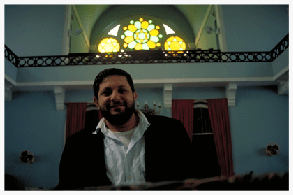Rabbi Moises el-Mescany, 37, is one of two rabbis serving nearly 600 remaining Jewish families in the Brazilian Amazon. Rabbi Moises, who trained in Jerusalem, grew up in Belem, one of the two large state capitals in the Brazilian Amazon. Both of the rabbi’s parents were born in Obidos, deep in the Amazon interior. Rabbi Moises remembers fondly his childhood vacations spent at his grandparents’ in Obidos. "They all taught me the Jewish traditions," he reflects, "lighting candles and saying kiddush on Shabbat, making Seders on Pesach, building sukkot, fasting on Yom Kippur. It was difficult because my grandmother sometimes felt alone in the jungle."