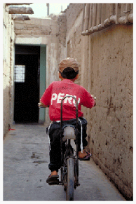 Nine year-old Meir Perez, wearing tsitsit, bicycles down the alley behind his home in Trujillo, Peru. Meir’s parents, community president Nilo Perez and Yona Perez, have practiced Judaism since before Meir’s birth. Judaism is the only religion young Meir has ever known. In the fall of 2001, with the help of Scattered Among the Nations leaders, a panel of visiting Orthodox rabbis formally converted the Perez family to Judaism. In 2002, the family immigrated to Israel in a group of 84 Inca Jews. Approximately 180 Inca Jews remain in Peru, awaiting the same opportunity.