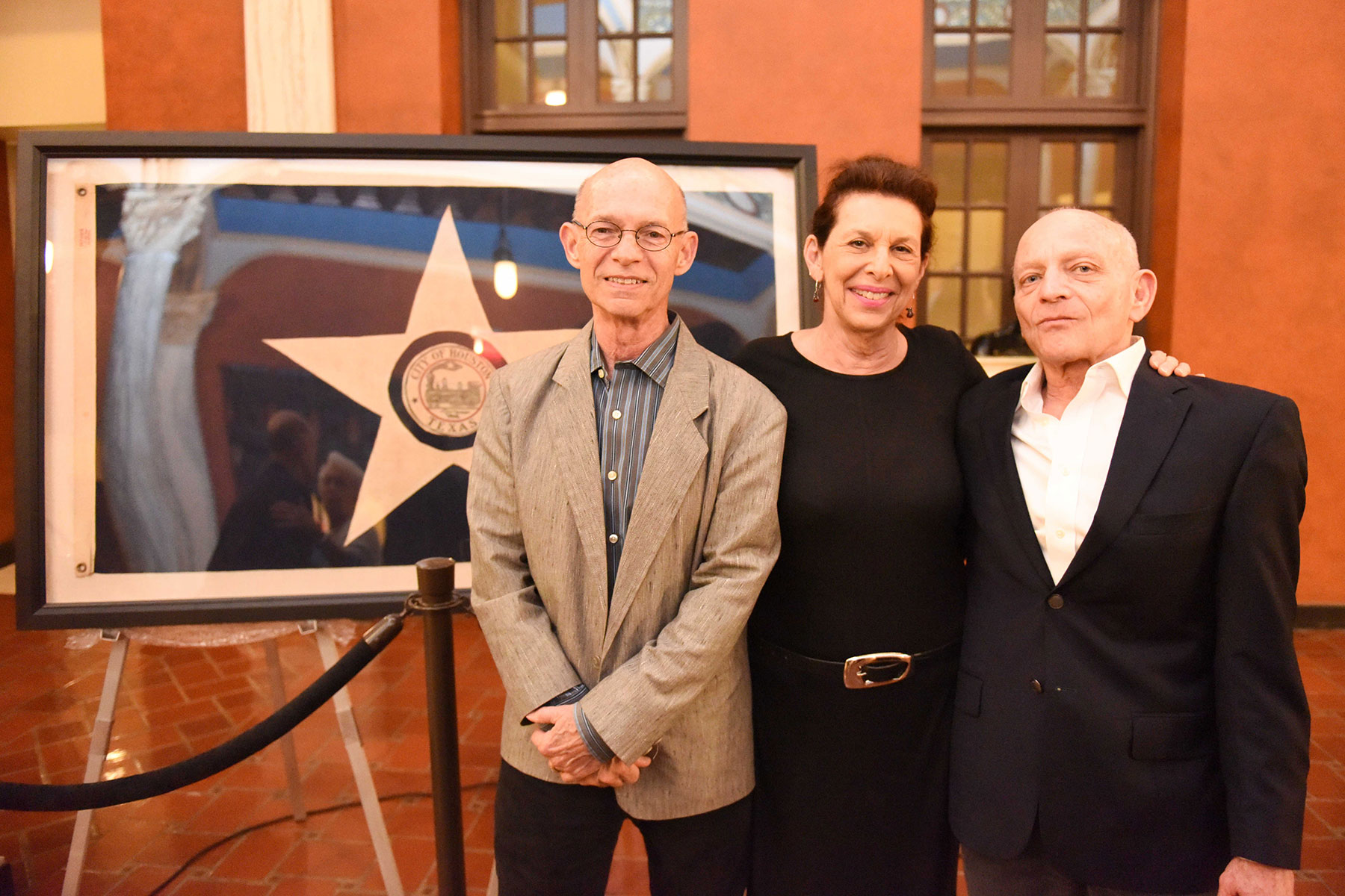  PH Director Emeritus Bart Truxillo (left) and textile conservator Jessica Hack (center), who restored the flag /&nbsp; photo by Daniel Ortiz  