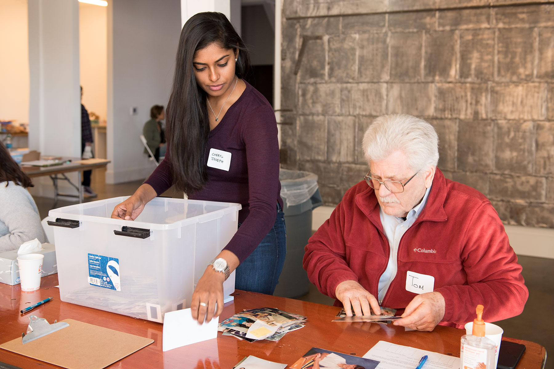 Cheryl Joseph and Tom Burkholder help sort photos for copying. / photo by Jim Parsons