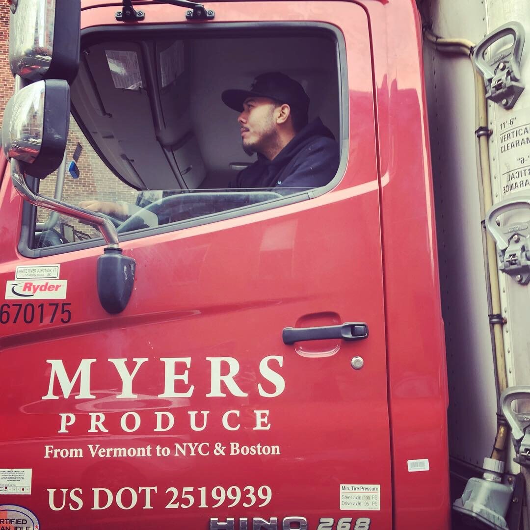 Person in the cab of a Myers Truck. 