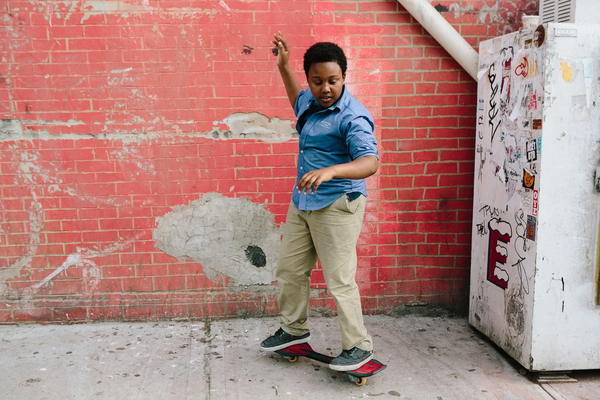 From The Atlantic: Justin, 14, plays on his skateboard as he waits for his brothers to bring out an after-school snack from the corner bodega in Brooklyn on May 20, 2015. Cassandra Giraldo