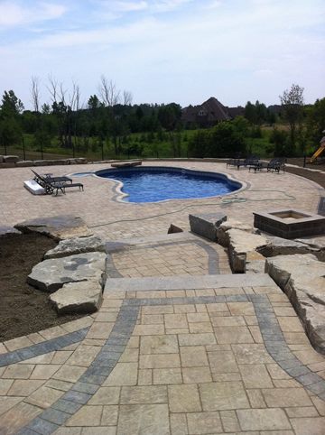 total back yard transformations by Unique Pools &amp; Landscaping Inc.