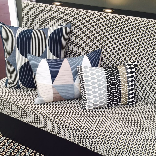 Mix geometric patterns. They all look good as long as you have a common colour theme and various sizes