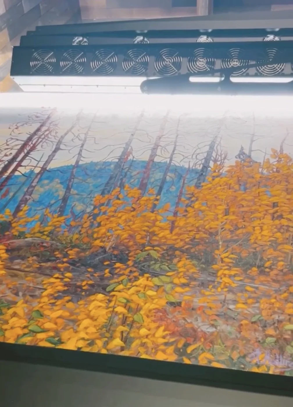 High-resolution scanning of an original painting for accurate color reproduction in giclée prints.