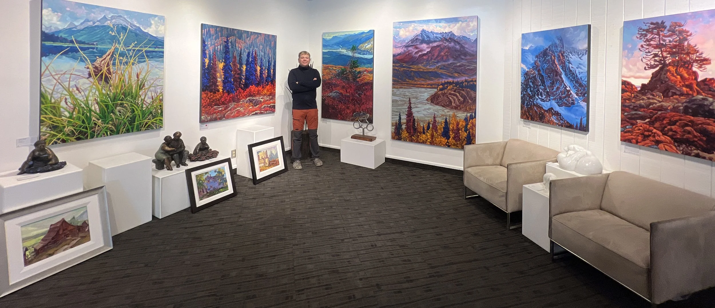 Artist Dominik Modlinski presenting his Canadian Rockies paintings at Canada House Gallery, showcasing his plein air and studio landscape works.