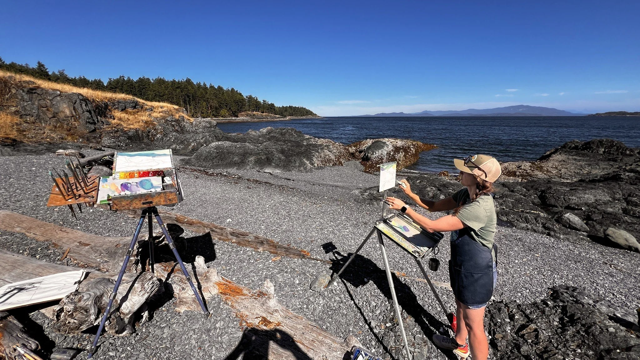 Finished plein air landscape paintings displayed on easels after a workshop session in Nanaimo on Vancouver Island.