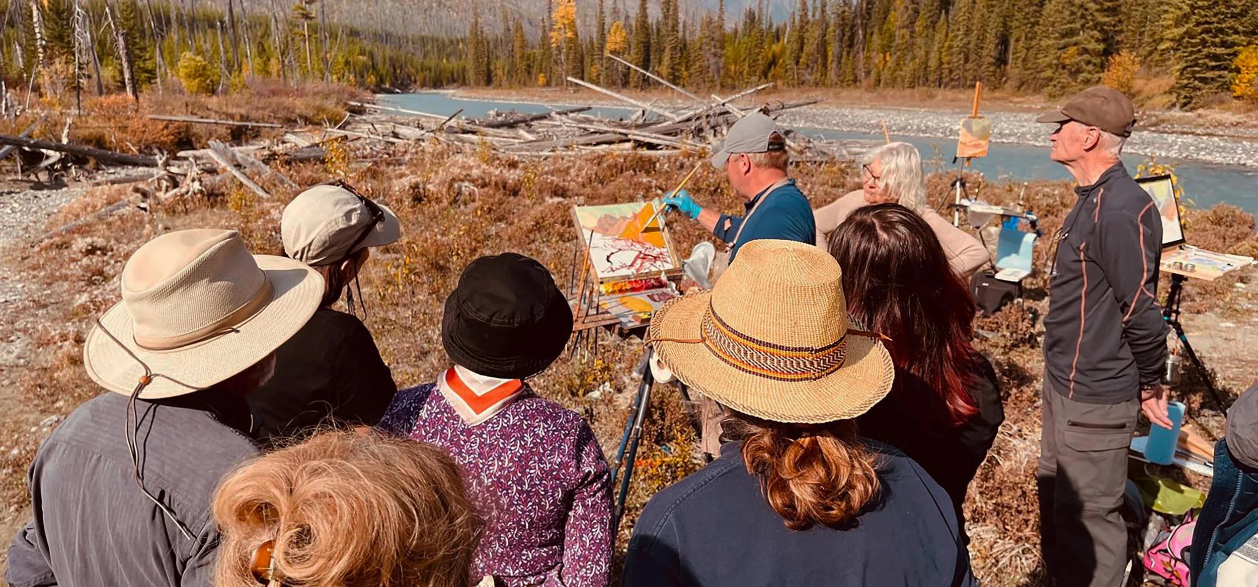 Artists participating in a plein air painting workshop in the Canadian Rockies, capturing the natural beauty of Canmore, Banff, and Bow Valley.