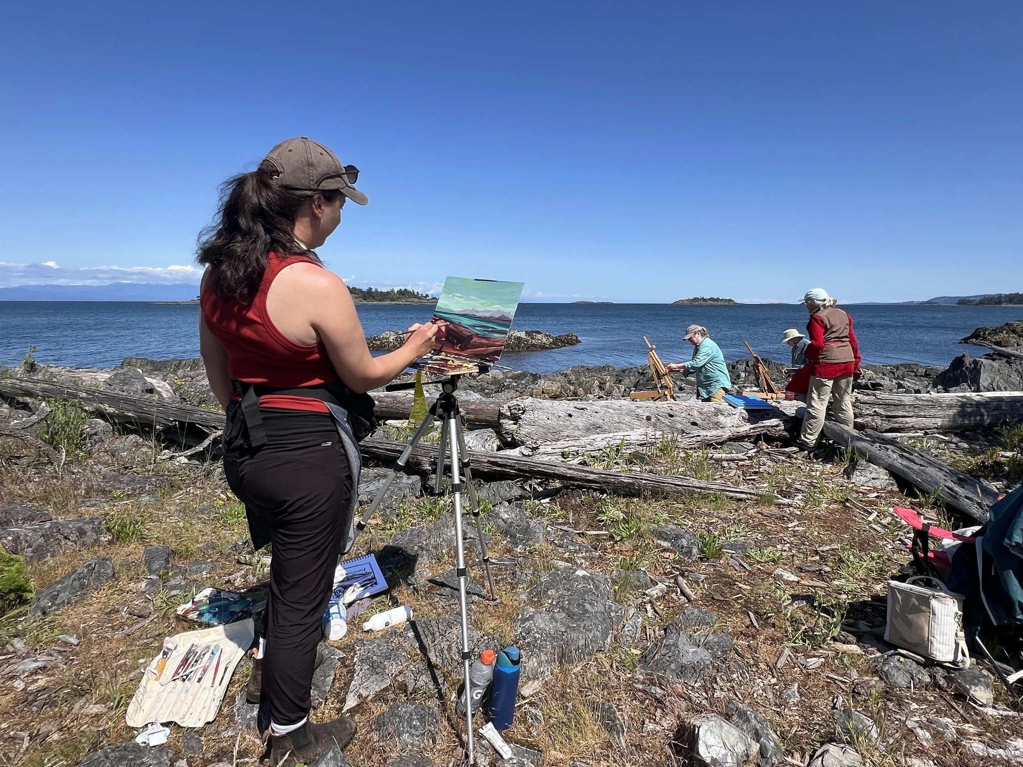 Plein air painters set up along the rocky coastline of Vancouver Island during a summer workshop near Nanaimo.