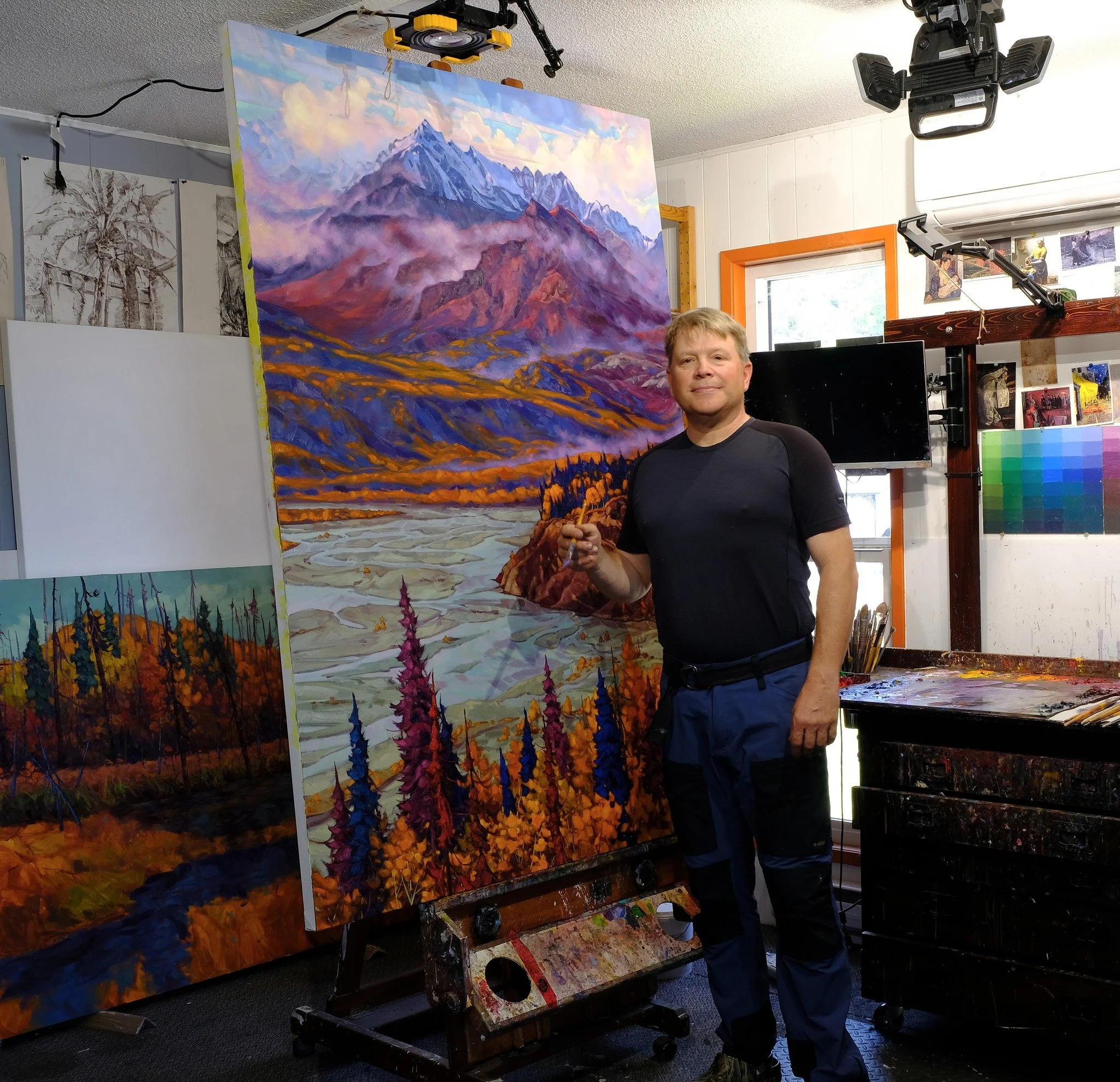 Dominik Modlinski painting in his studio, creating original Canadian landscape paintings available for sale