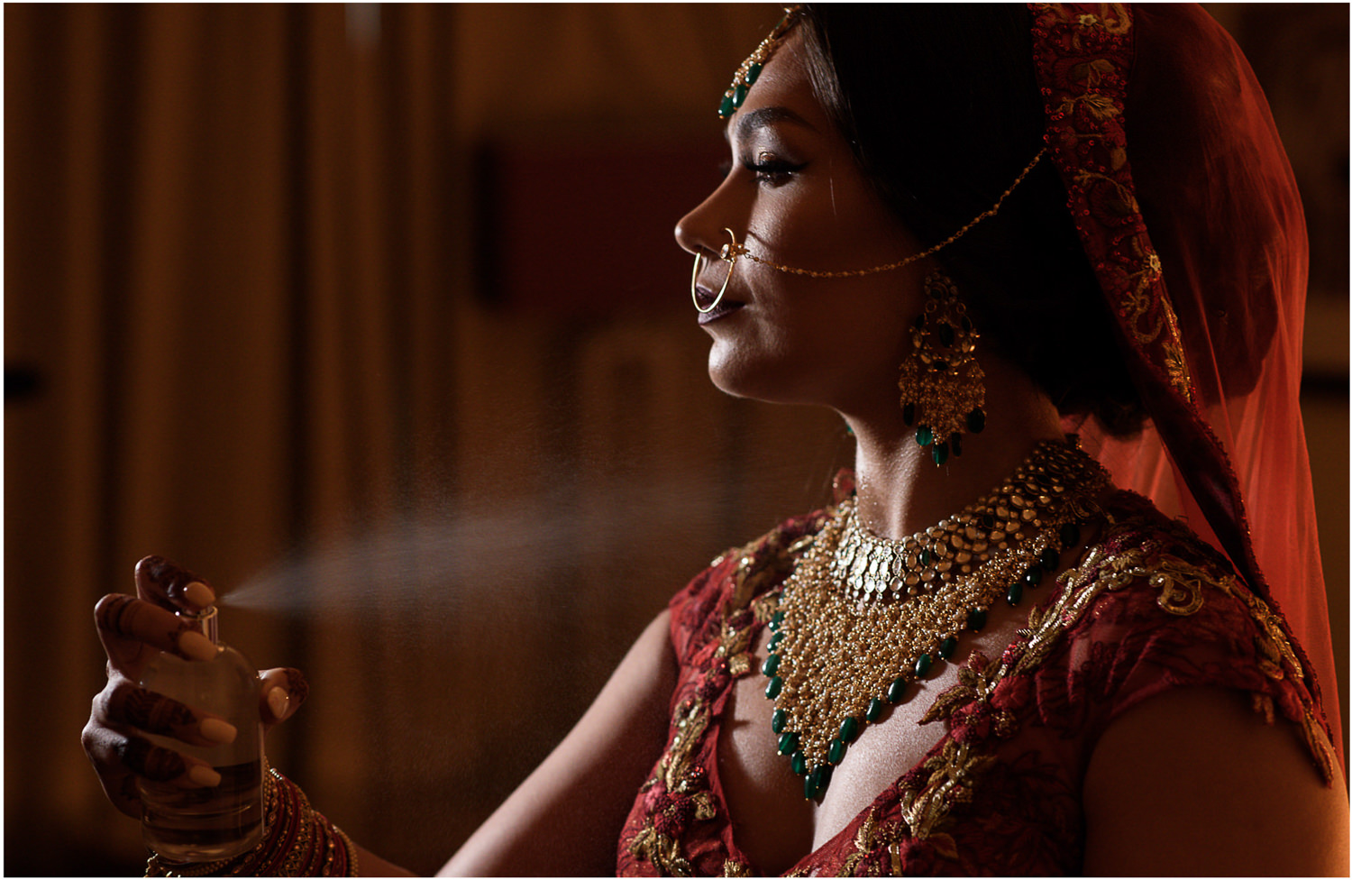 Indian bride spraying perfume