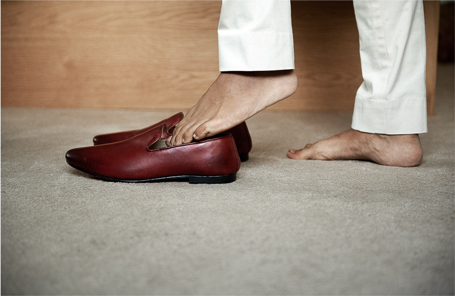 sikh groom putting on shoes in the morning