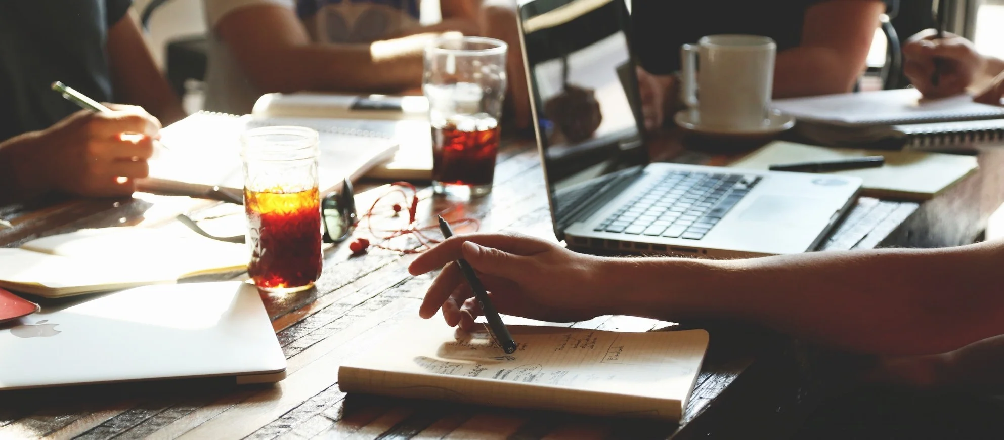 Image Description: Photo of a conference room table crowded with laptops, notebooks, and beverages with several people taking notes. People naturally find themselves embedded in social groups, or networks, of friends, family members, co-workers, teammates, acquaintances, etc. Research connects these networks with a variety of behavioral and health outcomes including, but not limited to: adaptation, emotional resilience, individual success, and team performance. This linkage is due, in large part, to the resources that networks can provide. However, being able to successfully access those resources depends critically on: (1) the ability to understand one’s complex network of interpersonal relationships and (2) being able to accurately navigate that network of relationships in order to activate the right resources at the right time. Both of these tasks are cognitively complex, and people naturally vary in their abilities to execute these tasks successfully. This research seek to understand the origins of differences in abilities to think about networks, map the consequences of those differences for individuals and teams, and develop tools that help people improve network-based reasoning abilities.