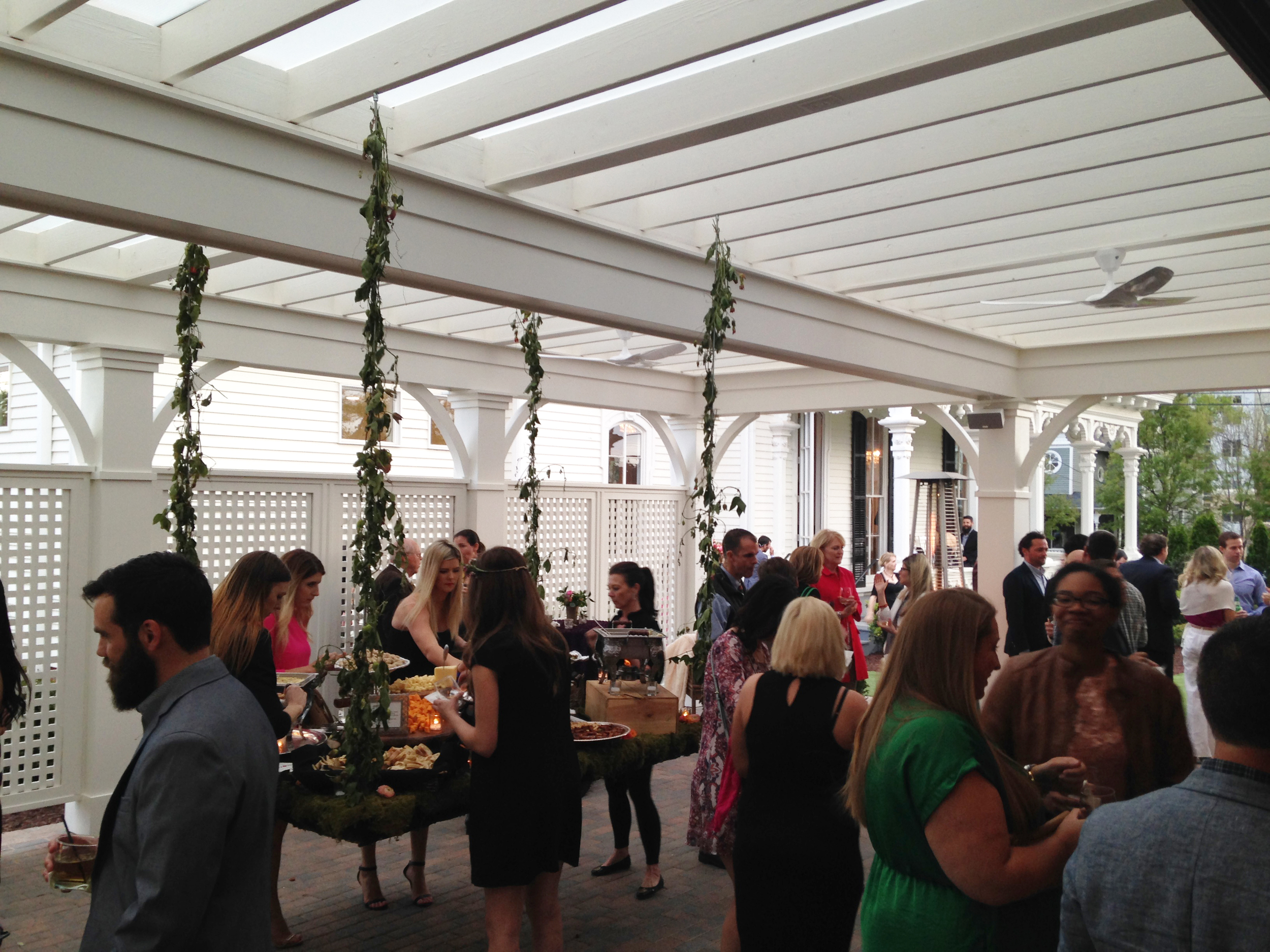 Party-goers enjoy the open air pergola at the Carriage House grand opening