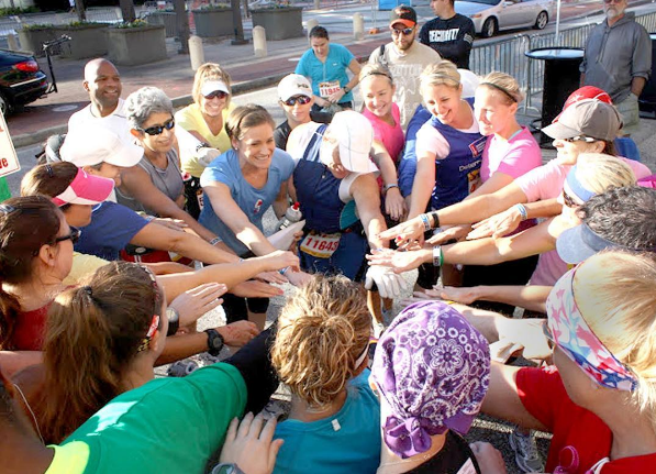 Coach Katie brings her half marathon training team in for a group pep talk.