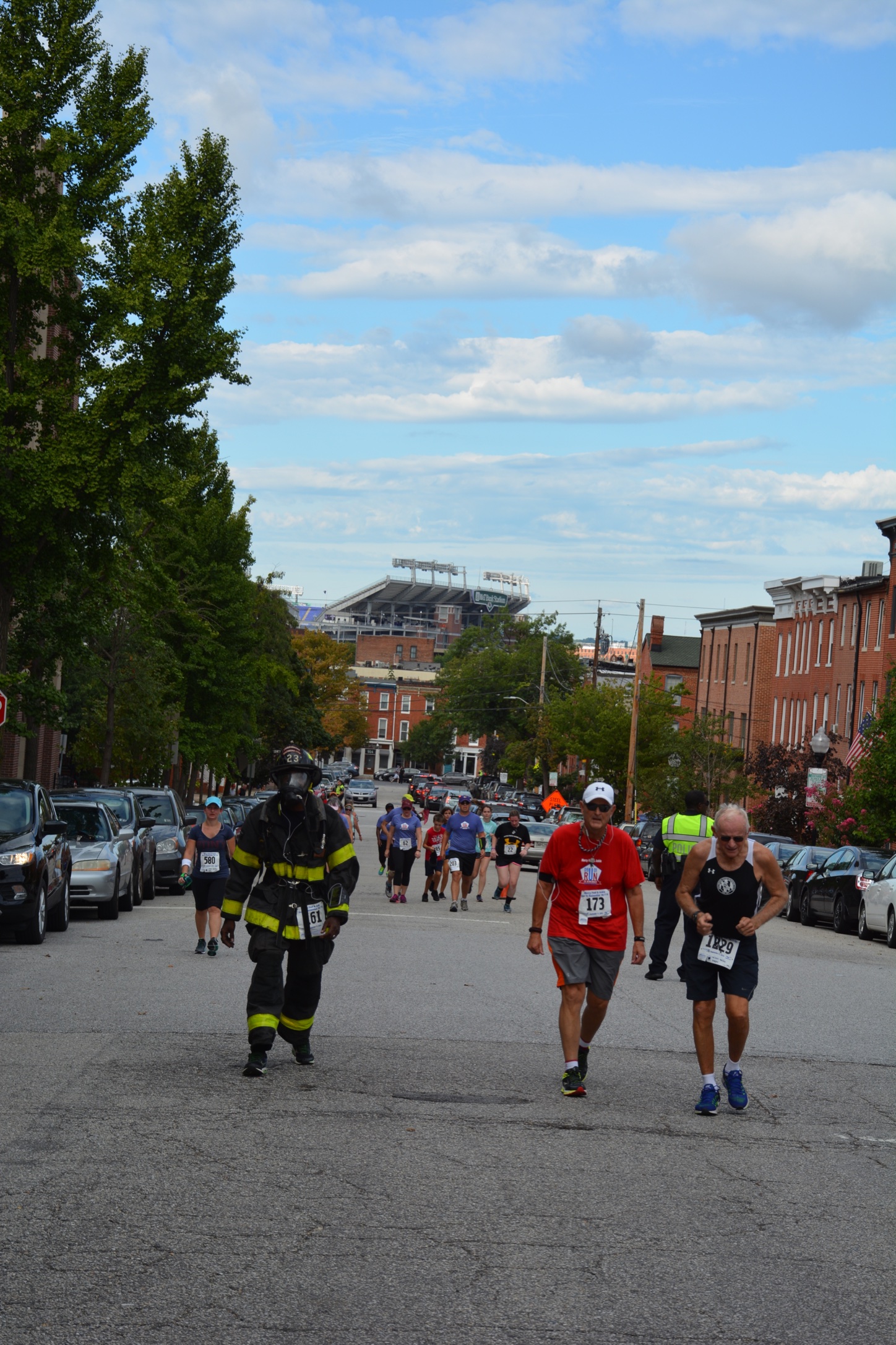 Tom (red shirt) strides up the last hill of the Run to Remember.