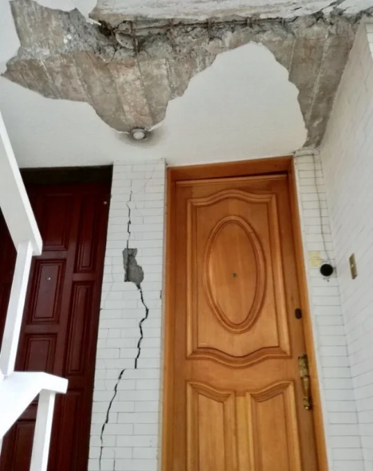 The threshold to the doorway of Joahna Hernandez's aunt. She can no longer live here because of structural damage to the building. 